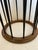 Mid century round glass top side table with elegant ebonized spindles and natural warm wood periphery around the glass and...