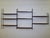 Modular String shelving unit in teak, 1960s. This wall-mounted unit consists of six black metal ladders and nine teak...