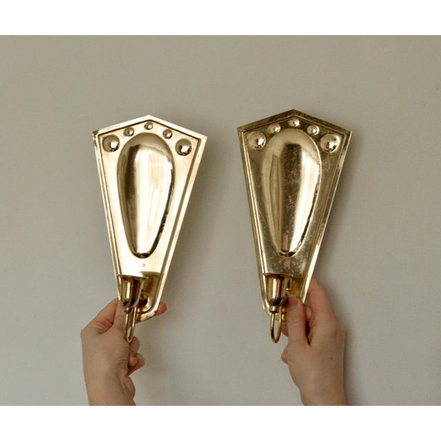 Made in Sweden A breath-taking mid-century duo of exquisite Swedish brass wall sconces, showcasing captivating hammered...