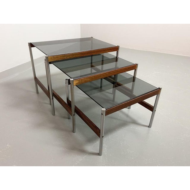 Set of 3 Dutch design nesting tables with smokey glass top on wenge with chrome frame. Manufactured with great...