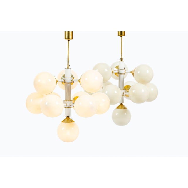 This matching pair of large mid-century modern Space Age Sputnik chandeliers was produced by Szarvasi in Hungary during...