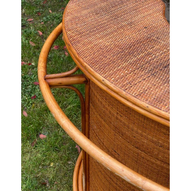 Charming half-moon shaped serving bar in bent rattan and woven wicker, resting on a solid and elegant frame. This piece is...