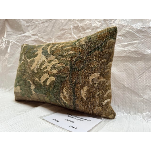 This decorative pillow is crafted from an authentic fragment of a 17th century Brussels tapestry, originating from the...