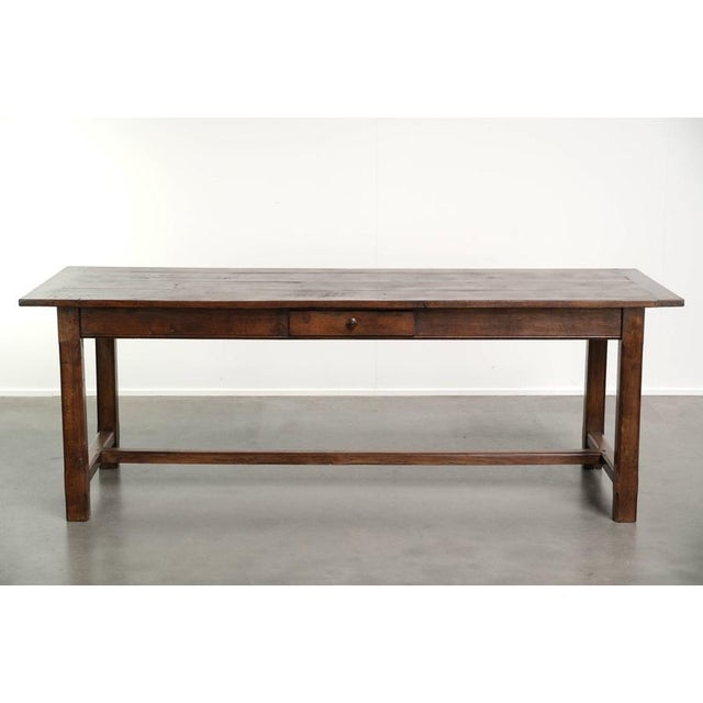 This beautiful antique French rustic oak dining table dates from the 18th century and features a drawer. The table has a...