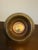 A charming vintage brass basket with a swing handle. The round bowl has a pierced lattice band around the rim above a...