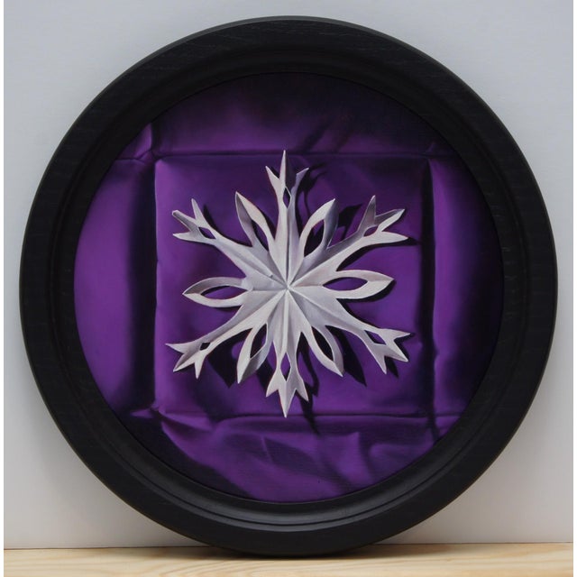 This artwork features a meticulously rendered paper snowflake, centered against a rich, purple backdrop that evokes a...