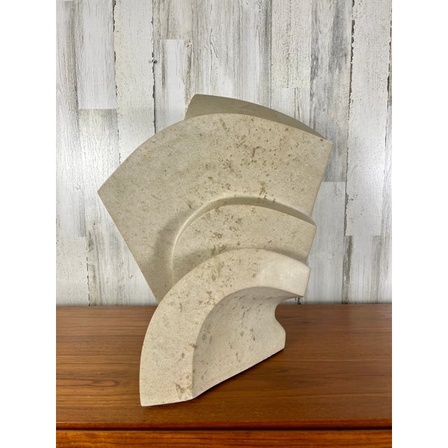 Beautifully carved out of one piece of beige marble it seems to have curved steps to a higher level, with some sharp...