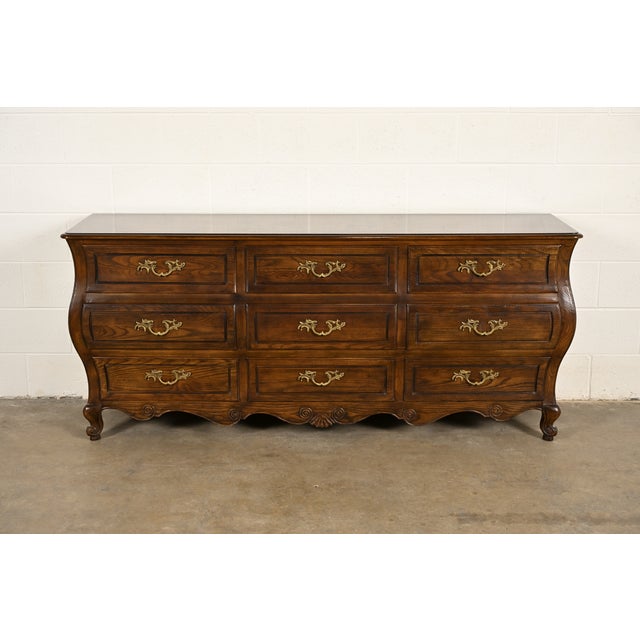 A beautiful French Provincial Louis XV style nine-drawer triple dresser or credenza By Baker Furniture USA, Circa 1980s...