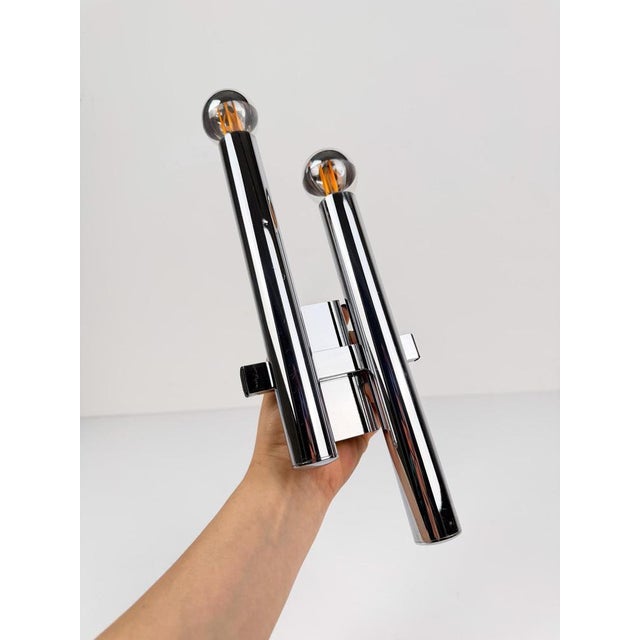 Two sets, each consisting of a pair of stunning and minimalist wall sconces produced by the historic Italian lighting...