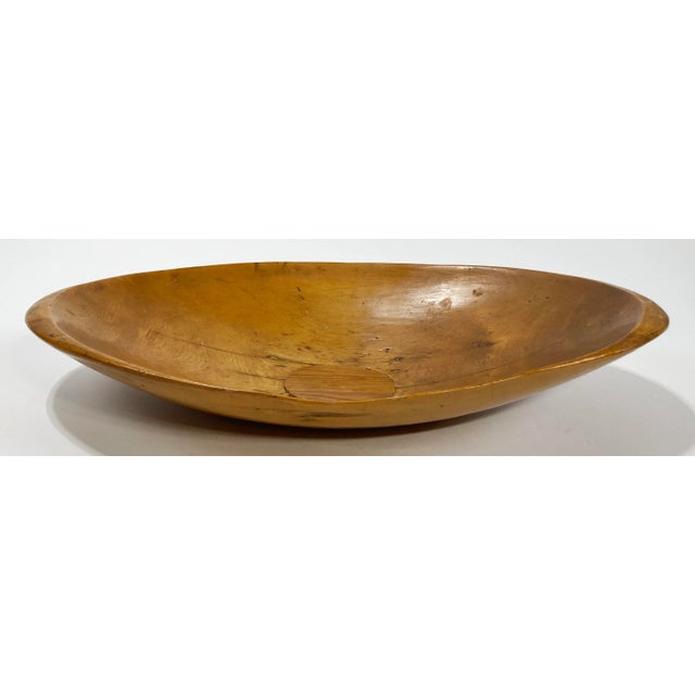 Antique wooden bowl with wonderful handmade character featuring irregular edge and center cut. Lovely patina.