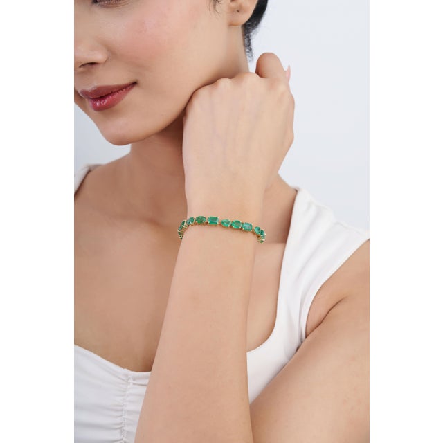This statement bracelet showcases 19.98 carats of mixed-cut natural Zambian emeralds, set in 14K yellow gold. Each emerald...