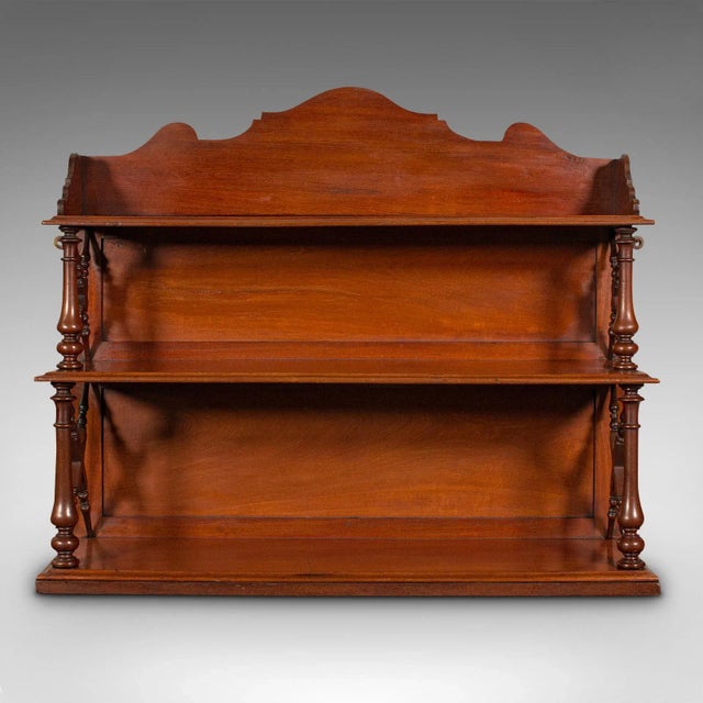 This is an antique mounted whatnot. An English, mahogany wall mounted book shelf, dating to the late Victorian period,...