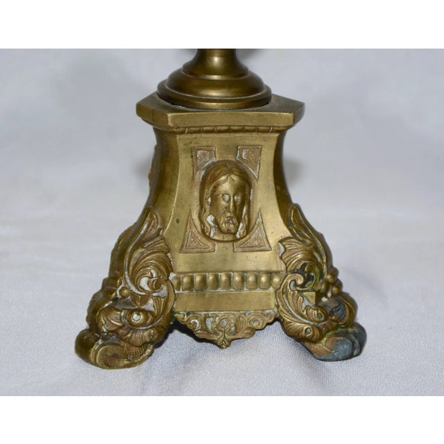 Heavy, solid cast brass forms this brass altar oil burner from Italy. Three different figures are on each side of the...