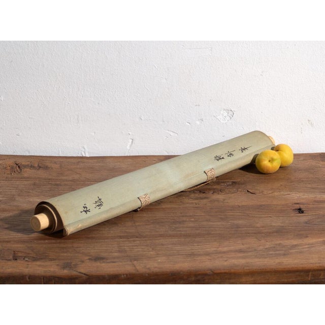 This antique japanese kakejiku is a hanging scroll of a crane in colour on paper, with a textile mount and wooden rods. It...