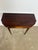 A finely proportioned George III mahogany fold-over demi lune / card table, dating to circa 1800, distinguished by elegant...