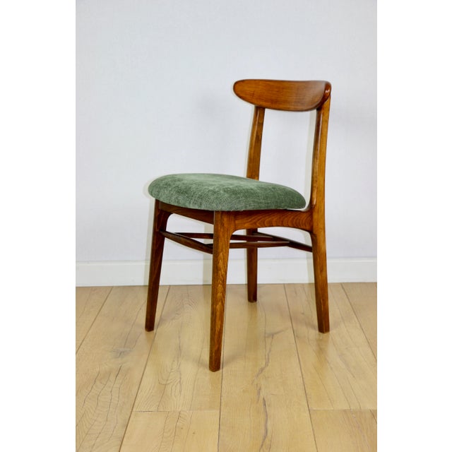 Hałas vintage chair in green with a wooden backrest. A completely restored original chair designed by Rajmund Hałas in the...