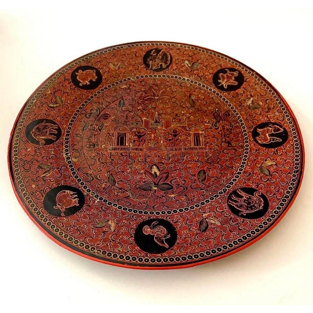 An exceptionally intricate antique Burmese lacquerware plate featuring eight animal medallions believed to represent the...