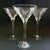 Elegant set of three vintage clear glass martini glasses featuring a delicate etched grape and vine motif. The wide,...