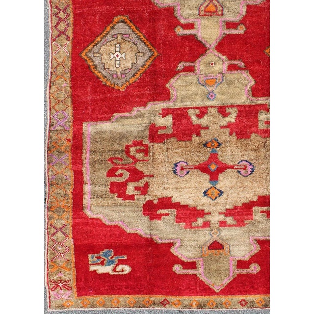 Measures: 5'11'' x 10'4''. This Turkish rug features a dual central medallion design as well as patterns of smaller Sub-...