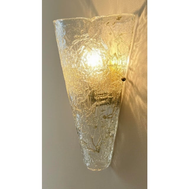 An impressive large vintage wall sconce featuring a heavy, thick handcrafted Murano ice glass shade. Sculpted into a...