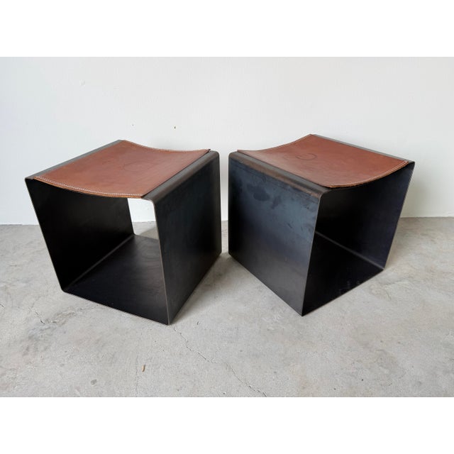 Striking vintage Italian postmodern ottomans featuring a bold sculptural cube form crafted from bent steel with a rich...