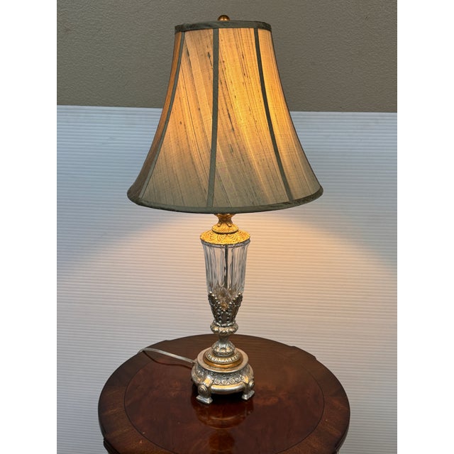 Design Plus Gallery presents a Neoclassical Cut Glass Table Lamp from Currey & Co. The lamp has an ornate cast-metal...