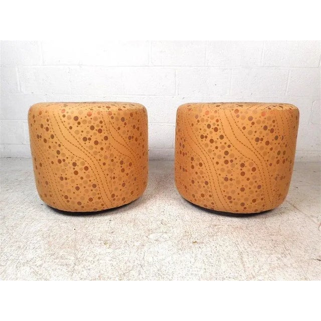 Stylish pair of vintage modern ottomansootstools. Interestingly designed vintage upholstery, with a tuft in the center of...