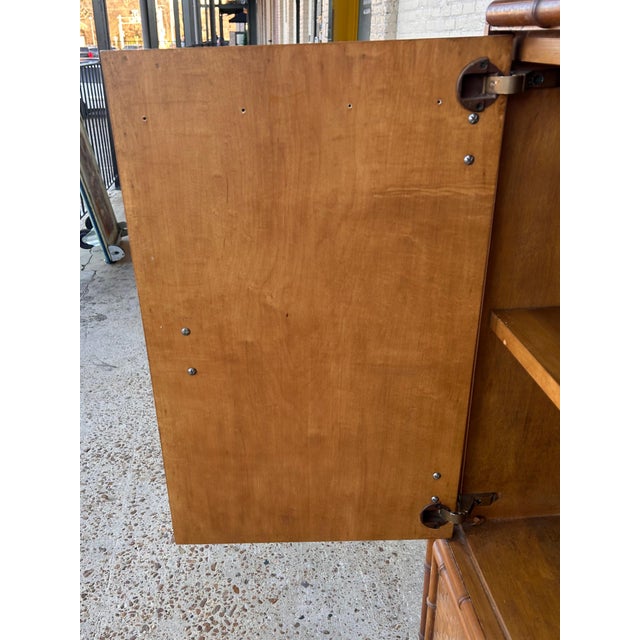 Vintage campaign style gentleman's dresser features faux bamboo detailing and a complete veneer of woven rattan basket...