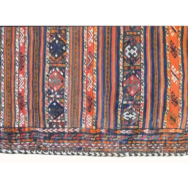 A wonderful early 20th century Persian Shahsevan bag face rug with several stylized floral patterned stripes on one side,...