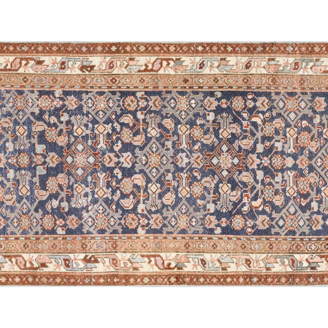 This semi-antique Melayer runner exemplifies traditional Persian craftsmanship, hand-woven with wool on a cotton...