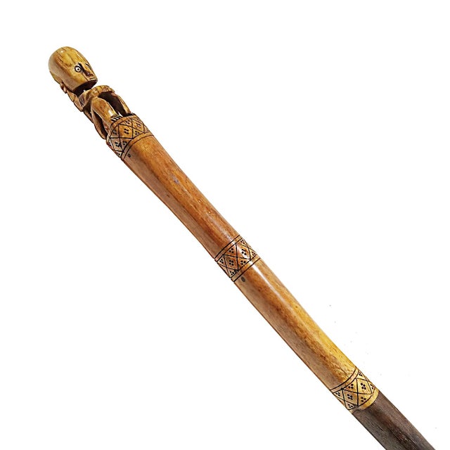 Two wooden batons, hand-carved in Borneo, Indonesia, late 20th Century. The two batons are made in two-tone Suar wood,...