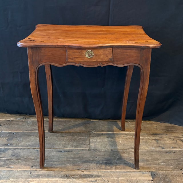 Refined French Louis XV side table or small desk of graceful proportion, crafted in richly patinated walnut with a...