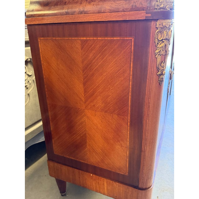 French art deco buffet with red marble top. Lovely ormolu and hardware. The combo of burl and stylized veneer makes this a...