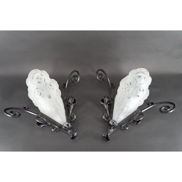 Important Pair of Wrought Iron Wall Sconces by Degué – Art Deco, France, circa 1930 Discover this remarkable pair of wall...