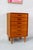 This teak chest of drawers combines ample storage space with a compact, balanced design. The warm wood tone and subtle...