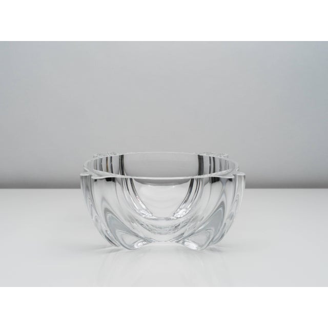 Large clear blown glass bowl or centerpiece by Barbini Murano for Oggetti. Four thick double-ridged extrusions flow down...
