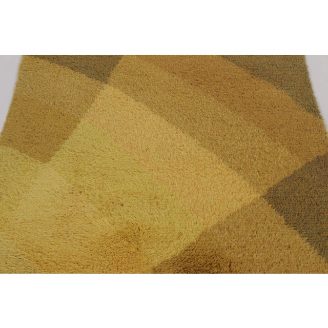 Hand-knotted in lush, high-pile wool in Sweden circa 1960-1970, this 4x6 vintage Swedish Rya rug is a bold new addition to...