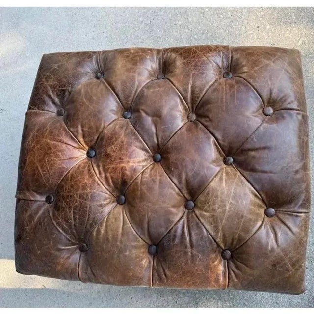 Vintage high quality ottoman with tufted aged leather. Substantial weight and expert craftsmanship. Leather has purposeful...