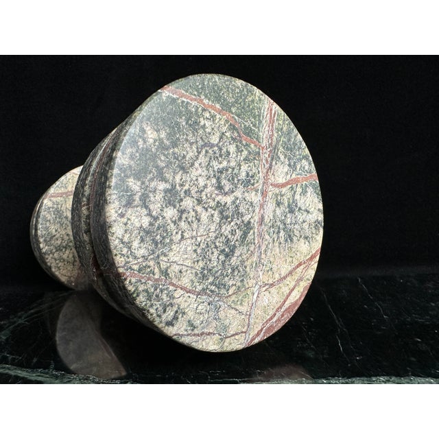 Tom Dixon "Rock" green marble dumbbell-shaped decorative weight from Tom Dixon's Rock collection, with rust-red veining....