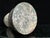 Tom Dixon "Rock" green marble dumbbell-shaped decorative weight from Tom Dixon's Rock collection, with rust-red veining....