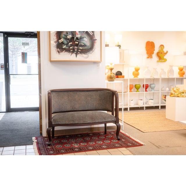 A traditional vintage curved settee bench seat. This beautiful bench features a stunning carved mahogany wood frame,...