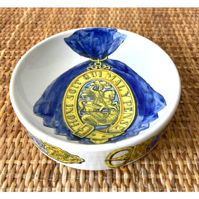 Fornasetti Blue and Yellow ceramic order of the garter ashtray/catchall with “Honi Soit Qui Mal Y Pense” motif at side and...