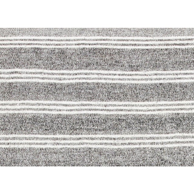 This vintage Turkish Rag Kilim, measuring 5'9" by 7'11", is handwoven in Western Turkey using recycled vintage fabric...