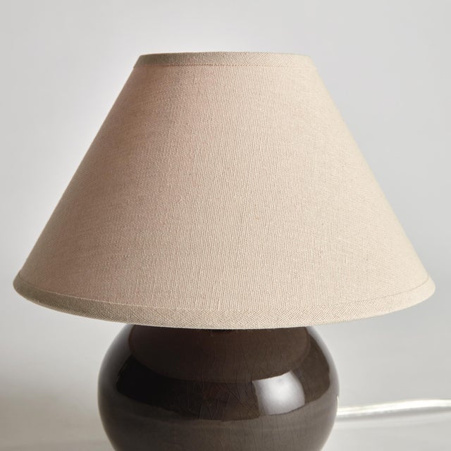 With a blue crackle glazed body and light linen shade, this lamp is a handsome fixture. At just around 10 inches tall, it,...