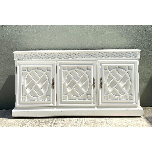 This stunning vintage Chinese Chippendale fretwork credenza is a masterclass in Chinoiserie elegance, perfectly capturing...