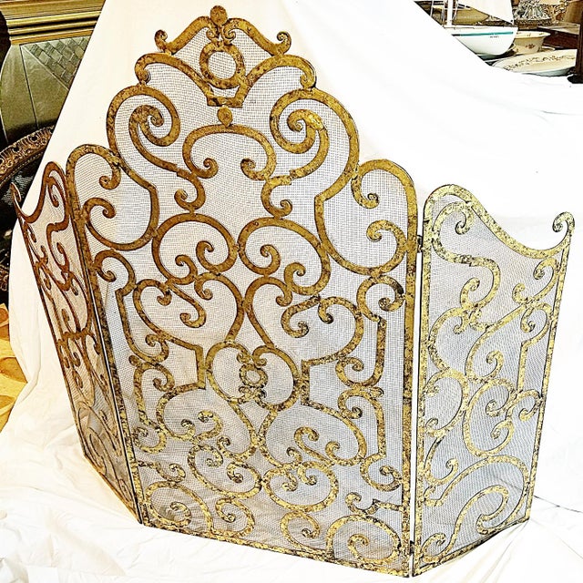 Simple elegance and practicality with this aged gilt finish metal fireplace screen with screen mesh backing, tri-folding...