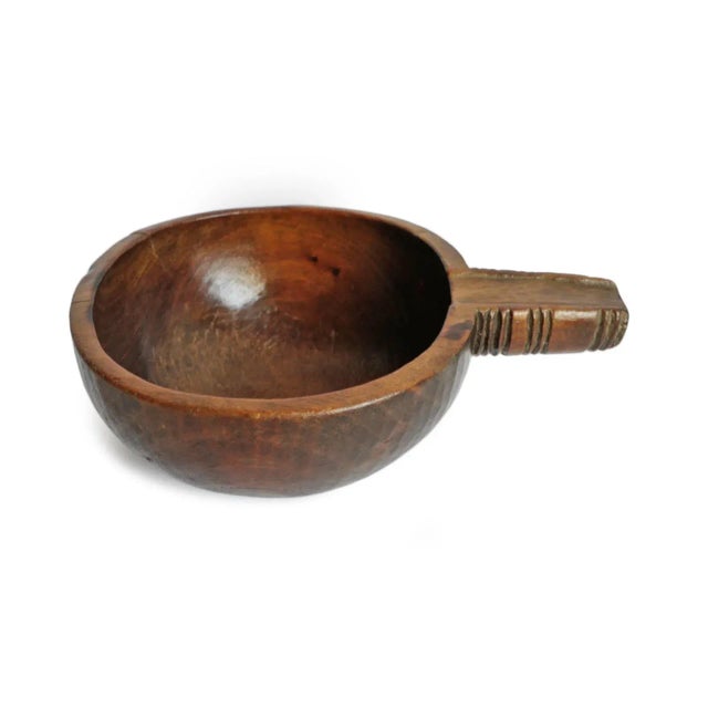 Vintage handmade teak wood bowl with handle from Nepal. Warm chestnut finish and beautiful signs of age and use.