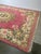 Beautiful large hand knotted rug from Cambodia featuring an elegant floral medallion design. The soft pink field is richly...