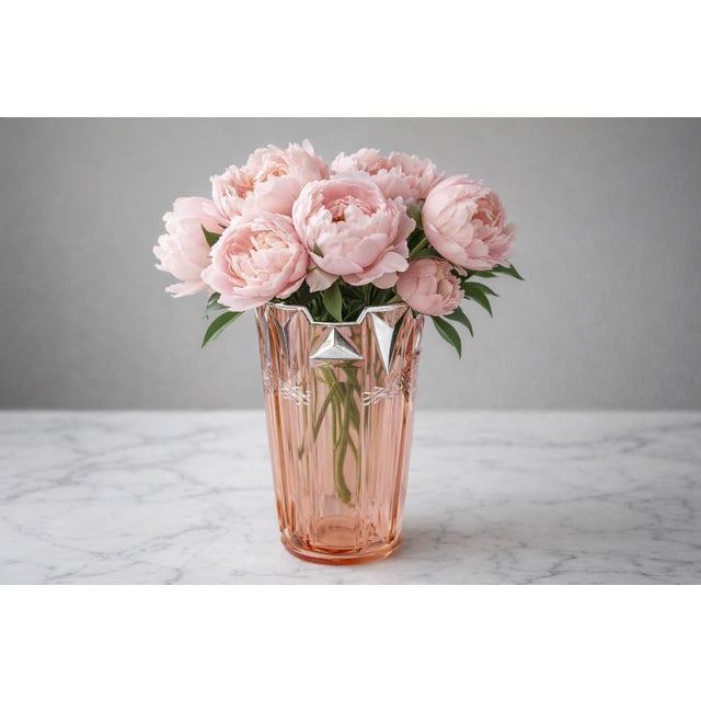 Early 20th century Art Deco pink glass vase featuring a striking faceted form with stepped rim and geometric silver...
