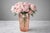 Early 20th century Art Deco pink glass vase featuring a striking faceted form with stepped rim and geometric silver...